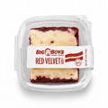 Red velvet cake in a clear plastic container with a Big Boy's Goody Cakes label on a white background